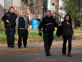 People are taken from a home at 10856 93 Street after a stand off with police occurred on Thursday, September 29, 2016 in Edmonton. Greg Southam / Postmedia