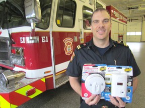 Mike Otis, public education officer with the Sarnia Fire Rescue Service, holds smoke and CO detectors in this file photo. During this year's Fire Prevention Week, running Oct. 9 to 15, Ontario residents are being encouraged to ensure they replace their smoke detectors every 10 years. (File photo)