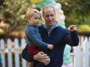 Prince George holds onto his father the Duke of Cambridge during a children's party at Government House in Victoria, B.C. Thursday, Sept 29, 2016. (THE CANADIAN PRESS/Jonathan Hayward)