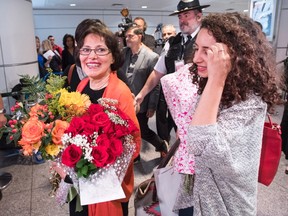 Homa Hoodfar, left, and her niece, Amanda Ghahremani, are greeted by friends and supporters as they arrive at Trudeau Airport Thursday, September 29, 2016 in Montreal. Hoodfar, a Canadian-Iranian academic was held in Iran's Evin prison for more than 100 days. (THE CANADIAN PRESS/Ryan Remiorz)
