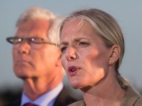 Catherine McKenna, front, Minister of Environment and Climate Change, announces the federal government's approval of the Pacific NorthWest LNG project as Jim Carr, Minister of Natural Resources, listens during a news conference at the Sea Island Coast Guard Base, in Richmond, B.C., on Tuesday September 27, 2016. (THE CANADIAN PRESS/Darryl Dyck)