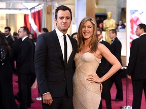 In this Feb. 22, 2015 file photo, Justin Theroux, left, and Jennifer Aniston arrive at the Oscars in Los Angeles. (Photo by Chris Pizzello/Invision/AP, File)