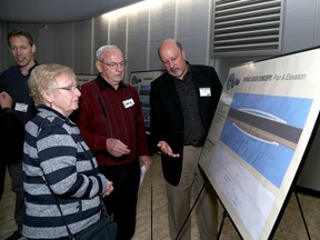 Greenwood Park residents Jean and Gary Richards talk to Mark Landridge of architectural firm DTAH of Toronto during an open house on the third crossing at La Salle Secondary School on Thursday. (Ian MacAlpine /The Whig-Standard)