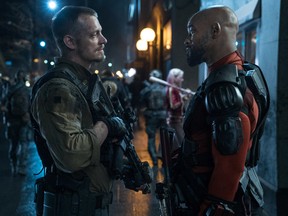 This image released by Warner Bros. Pictures shows, Joel Kinnaman, left, and Will Smith in a scene from "Suicide Squad." (Clay Enos/Warner Bros. Pictures via AP)