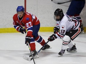 Strathroy Rockets forward Matthew Stevens and Alec Scarsella of the Sarnia Legionnaires both reach for the puck during the Greater Ontario Junior Hockey League game at Sarnia Arena on Thursday, Sept. 29, 2016 in Sarnia, Ont. Sarnia rallied for a 5-4 overtime win. (Terry Bridge/Sarnia Observer)