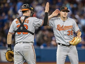 Baltimore Orioles' Brad Brach (right) and Matt Wieters celebrate defeating the Toronto Blue Jays in MLB baseball action in Toronto on Sept. 29, 2016.  (MARK BLINCH/CP)