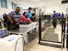 Passengers arriving from international flights pass through an expedited Transportation Security Administration checkpoint at a new direct passageway to domestic flights at Los Angeles International Airport, in Los Angeles, Thursday, Sept. 29, 2016. (AP Photo/Nick Ut)