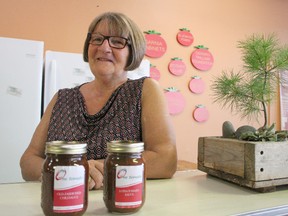 One Tomato board member Linda Weening shows off jars of its Old-Fashioned Chili Sauce and Lotsa Tomato Sauce. The Sarnia-based non-profit will be selling its first three food products to the public as part of the upcoming First Friday festivities set for Oct. 7. Barbara Simpson/Sarnia Observer/Postmedia Network