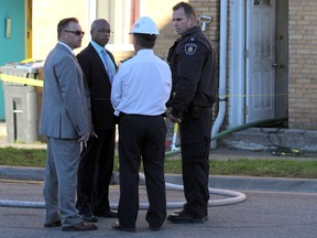 Deputy Chief Paul Milosevich speaks with detectives from Sault Ste. Marie Police Service near an apartment fire where a man died early Friday.