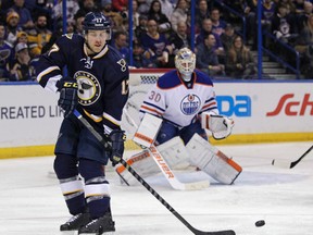 Blues' Jaden Schwartz redirects the puck past Oilers goalie Ben Scrivens for a goal during NHL action on Jan. 13, 2015. Schwartz is out at least a month with an elbow injury, the Blues announced on Friday, Sept. 30, 2016. (Tom Gannam/AP Photo/Files)