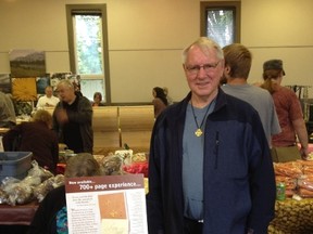 Glen Carlson stands at his booth with copies of his newest book, A Listening Bible at the Stony Plain Farmers’ Market. - Photo submitted