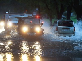 Vehicles pass through a section of Jefferson Blvd. that was flooded on Thursday, September 29, 2016, in Windsor, Ont. Heavy rains caused flooding in much of the area. (Dan Janisse/Windsor Star/Postmedia Network)