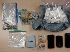 More than $100,000 in cocaine, cash and property seized by the Kingston Police Thursday night in Kingston, Ont. Photo supplied by the Kingston Police