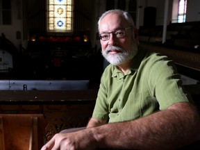 Tim Miller/The Intelligencer
Rev. David Mundy sits in a pew in the balcony of Bridge Street United Church on Friday in Belleville. The church is one part of a sponsorship group for Syrian refugee families.