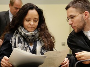 Terror suspect Beate Zschaepe (L) talks with her lawyer Mathias Grasel as she waits for the continuation of her trial at the court room in Munich, southern Germany, on September 29, 2016. (MATTHIAS SCHRADER/AFP/Getty Images)