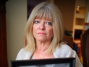 Bonnie Bricker holds a photo of her son Reid. Reid died from suicide. (Brian Donogh/Winnipeg Sun)