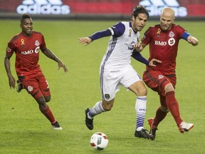 Toronto FC’s Michael Bradley battles with Orlando City’s Kaka during Wednesday’s game. (THE CANADIAN PRESS)