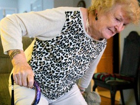 Eleanor McLaughlin of London grimaces as she rises out of her chair. McLaughlin is waiting for a knee replacement after years ago getting a new hip in London, Ont. Photograph taken on Thursday September 29, 2016. (MIKE HENSEN, The London Free Press)