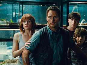 This photo provided by Universal Pictures shows, Bryce Dallas Howard, from left, as Claire, Chris Pratt as Owen, Nick Robinson as Zach, and Ty Simpkins as Gray, in a scene from the film, "Jurassic World," directed by Colin Trevorrow, (Universal Pictures/Amblin Entertainment)