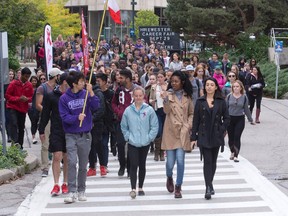 More than 100 people walk through London?s Western University campus during Andrea?s Walk to End Drunk Driving, an event honouring Andrea Christidis, the 18-year-old student killed by a drunk driver on campus last year. Proceeds from the event, organized by health sciences students, went to Mothers Against Drunk Driving. (CRAIG GLOVER, The London Free Press)
