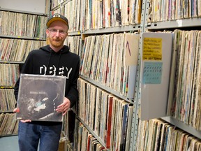 CHRW program director Andrew Barton holds an LP from the London Experimental Jazz Quintet, one of the station?s nearly 10,000 records being sorted and catalogued. (CRAIG GLOVER, The London Free Press)