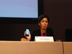 Sonia Paquet, a Canadian prosecutor, holds a cell phone displaying online reviews of establishments that sell illegal sex. Prosecutors from around the world say the fight against sex trafficking is moving online as traffickers use popular websites to advertise sexual services. They talked Friday, Sept. 30, 2016, about how they can crack down on the problem at an international sex trafficking summit in Waikiki that drew prosecutors from Asia, the U.S. and Canada. (AP Photo/By Cathy Bussewitz)