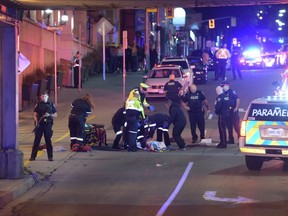 Paramedics and cops at the scene where a man was shot in the chest in Hamilton late Friday, Sept. 30, 2016. The man later died in hospital. (Photo by Andrew Collins)