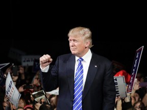 Republican presidential candidate Donald Trump reacts after speaking at a rally, Friday, Sept. 30, 2016, in Novi, Mich. (AP Photo/John Locher)