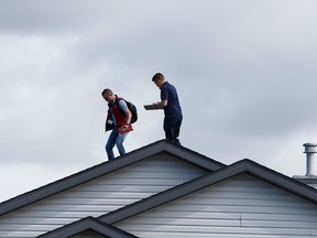 Insurance adjustors check the roof of a home in the Wood Buffalo neighbourhood in Fort McMurray, Alta., on Friday June 3, 2016. 
Photo by Ian Kucerak/ Postmedia Network