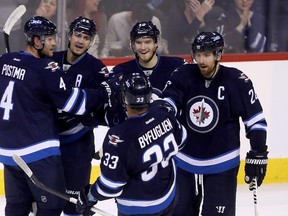 Winnipeg Jets' Paul Postma (4), Mark Scheifele (55), Joel Armia (40), Dustin Byfuglien (33) and Blake Wheeler (26) celebrate after Armia scored against the Edmonton Oilers during first period pre-season NHL hockey in Winnipeg, Friday, September 30, 2016. (THE CANADIAN PRESS/Trevor Hagan)