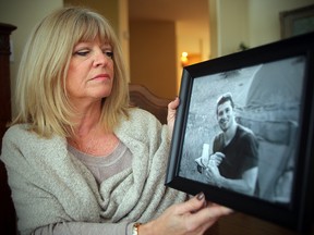 Bonnie Bricker holds a photo of her son Reid in Winnipeg, Man. Tuesday September 27, 2016. (Brian Donogh/Winnipeg Sun/Postmedia Network)