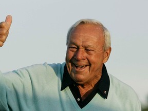 Former Masters champion Arnold Palmer acknowledges the crowd after hitting the ceremonial first tee shot prior to the first round of the 2007 Masters golf tournament at the Augusta National Golf Club in Augusta, Ga. Palmer, who made golf popular for the masses with his hard-charging style, incomparable charisma and a personal touch that made him known throughout the golf world as "The King," died Sunday, Sept. 25, 2016, in Pittsburgh. He was 87. (AP Photo/David J. Phillip, File)