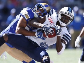 Winnipeg Blue Bombers' Johnny Adams wraps up Toronto Argonauts' Kenny Shaw during the first half of CFL action in Winnipeg Saturday, September 17, 2016. (THE CANADIAN PRESS/John Woods)