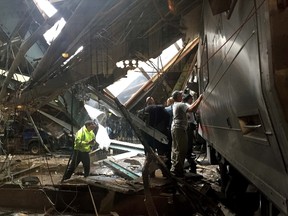 Train personel survey the NJ Transit train that crashed in to the platform at the Hoboken Terminal September 29, 2016 in Hoboken, New Jersey. New Jersey emergency's management system is reporting more than 100 people were injured in the crash.(Photo by Pancho Bernasconi/Getty Images)
