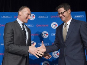 Toronto Blue Jays new general manager Ross Atkins, right, and Blue Jays president and CEO Mark Shapiro shake hands after answering questions during a press conference in Toronto on Friday, December 4, 2015. (THE CANADIAN PRESS/Nathan Denette)