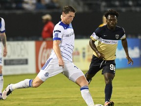 FC Edmonton midfielder Daryl Fordyce plays a ball with Jacksonville Armada midfielder Charles Eloundou looking on in North American Soccer League play, Wednesday Sept 28, 2016 in Jacksonville, Florida. FC Edmonton host the Indy Eleven on Sunday (2 p.m.) at Clarke Stadium.