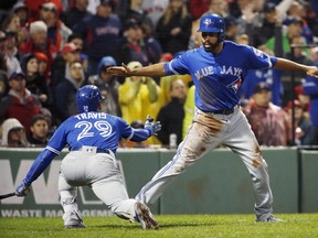 Toronto Blue Jays' Dalton Pompey, right, celebrates with Devon Travis (29) after scoring on a sacrifice fly by Ezequiel Carrera during the ninth inning of a baseball game against the Boston Red Sox in Boston, Saturday, Oct. 1, 2016. (AP Photo/Michael Dwyer)