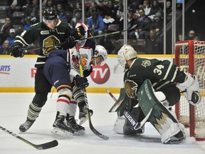 Brandon Crawley of the London Knights shoves Ben Hawerchuk of the Barrie Colts off his skates as drama unfolds in front of the net during first period OHL action held saturday at the Barrie Molson Center. Mark Wanzel/Barrie Examiner/Postmedia Network