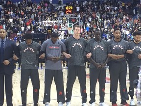 Toronto Raptors lock arms in protest while the anthems play prior to facing the Warriors in pre-season action in Vancouver on Saturday, Oct. 1, 2016. (Mike Ganter/Toronto Sun)