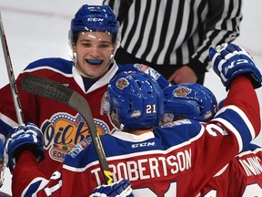 Edmonton Oil Kings teammates celebrate Tyler Robertson's goal on Red Deer Rebels goalie Trevor Martin (35) in WHL action at Rogers Place, the first-ever hockey game in the new arena in Edmonton Saturday, September 24, 2016.