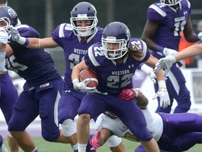 Western Mustangs Myles Rombough shakes the tackle from Laurier linebacker Nakas Omyeka an OUA game against Laurier at TD Waterhouse stadium in London, Ontario on Saturday Oct 1, 2016. At left is Western's Mitchell Smiley
MORRIS LAMONT/THE LONDON FREE PRESS /POSTMEDIA NETWORK