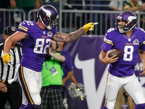 Vikings tight end Kyle Rudolph (left) celebrates with quarterback Sam Bradford (right) after catching an 8-yard touchdown pass against the Packers during NFL action in Minneapolis on Sept. 18, 2016. (Andy Clayton-King/AP Photo)
