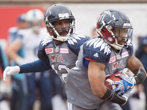 Montreal Alouettes quarterback Rakeem Cato, left, hands off to Tyrell Sutton during first half CFL football action against the Toronto Argonauts in Montreal, Sunday, Oct. 2, 2016. (THE CANADIAN PRESS/Graham Hughes)