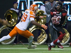 Redblacks' Chris Williams (right) makes a reception before running it for a touchdown as Lions' Chandler Fenner defends during first half CFL action in Vancouver on Saturday, Oct. 1, 2016. (Darryl Dyck/The Canadian Press)