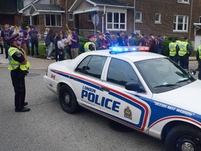 London police closed traffic down on Broughdale Ave during a Western University student street party to to celebrate reunion weekend in London, Ontario on Saturday Oct 1, 2016. (MORRIS LAMONT, The London Free Press)