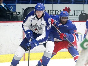Kitchener Rangers Elijah Roberts  and Sudbury Wolves  Liam Dunda battle for the puck during OHL action from the Sudbury Community Arena in Sudbury, Ont. on Sunday October 2, 2016. Gino Donato/Sudbury Star/Postmedia Network