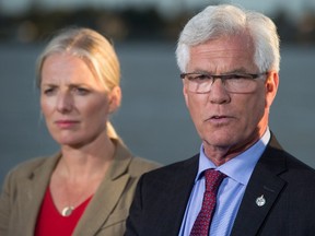 Jim Carr, right, Minister of Natural Resources, speaks as Catherine McKenna, Minister of Environment and Climate Change, listens after the federal government announced approval of the Pacific NorthWest LNG project, at the Sea Island Coast Guard Base in Richmond, B.C., on Tuesday September 27, 2016. (THE CANADIAN PRESS/Darryl Dyck)