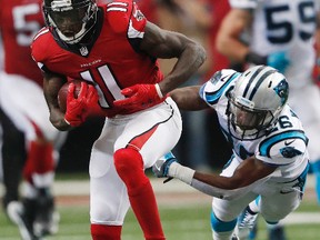 Falcons wide receiver Julio Jones (11) runs past Panthers cornerback Daryl Worley (26) during second half NFL action in Atlanta on Sunday, Oct. 2, 2016. (John Bazemore/AP Photo)