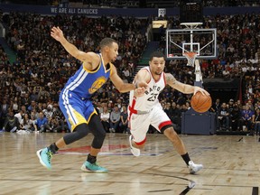 Raptors' Fred VanVleet (23) drives to the basket against Warriors' Stephen Curry (30) during a pre-season game in Vancouver on Saturday, Oct. 1, 2016. (Jeff Vinnick/NBAE via Getty Images)