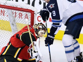 Calgary Flames goaltender Chad Johnson stops this shot from the Winnipeg Jets' Andrew Copp during NHL preseason action in Calgary on Sunday Oct. 2, 2016. Gavin Young/Postmedia